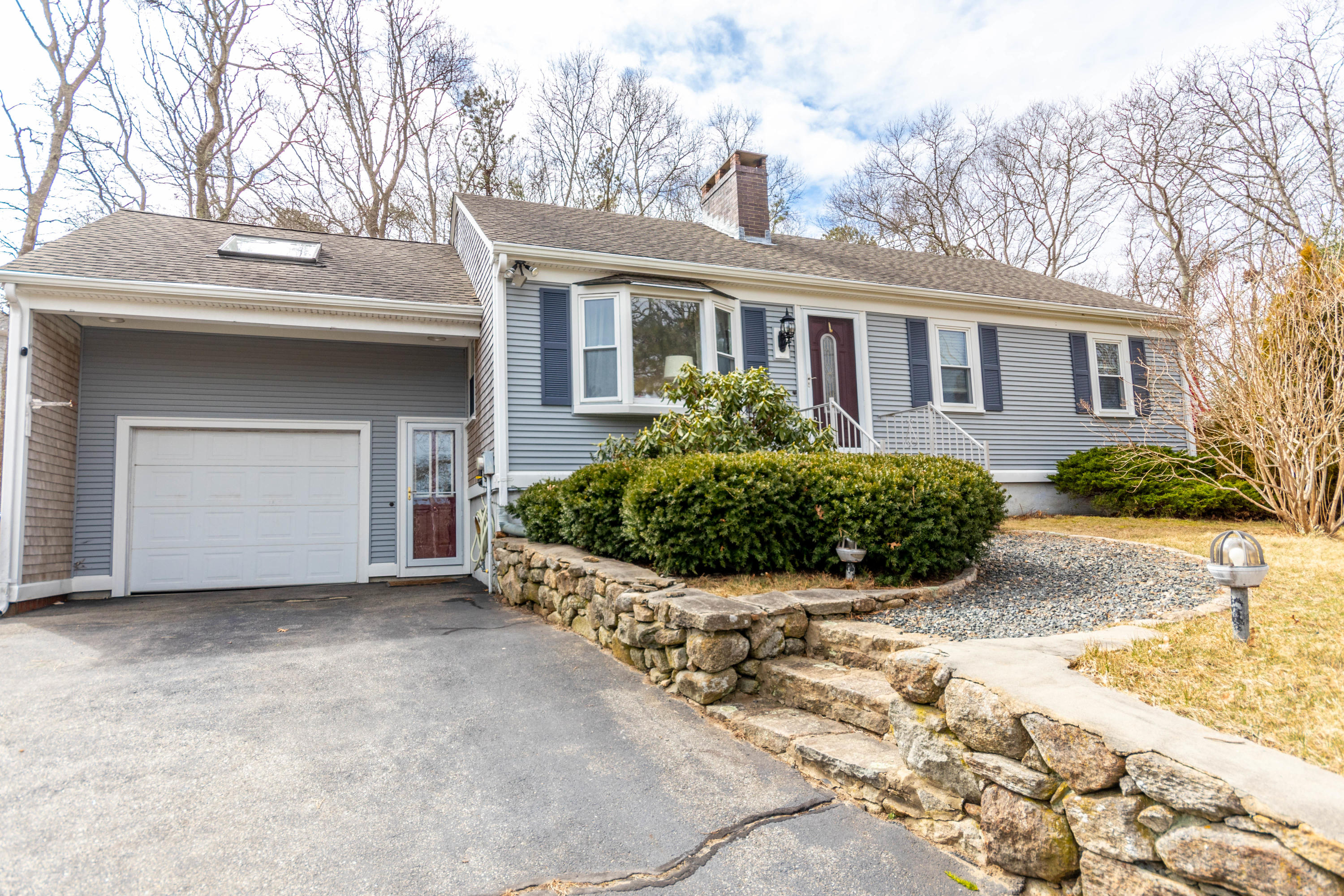 2 Long Boat Road Bourne, MA 02532 - Photo 2 of 30 a front view of a house with a garden