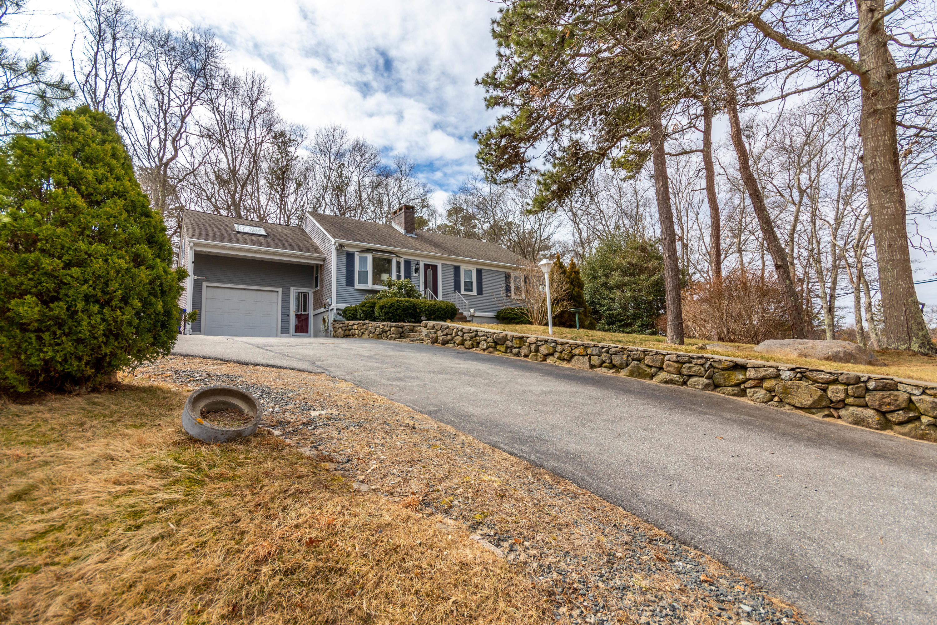 2 Long Boat Road Bourne, MA 02532 - Photo 25 of 30 a front view of a house with trees