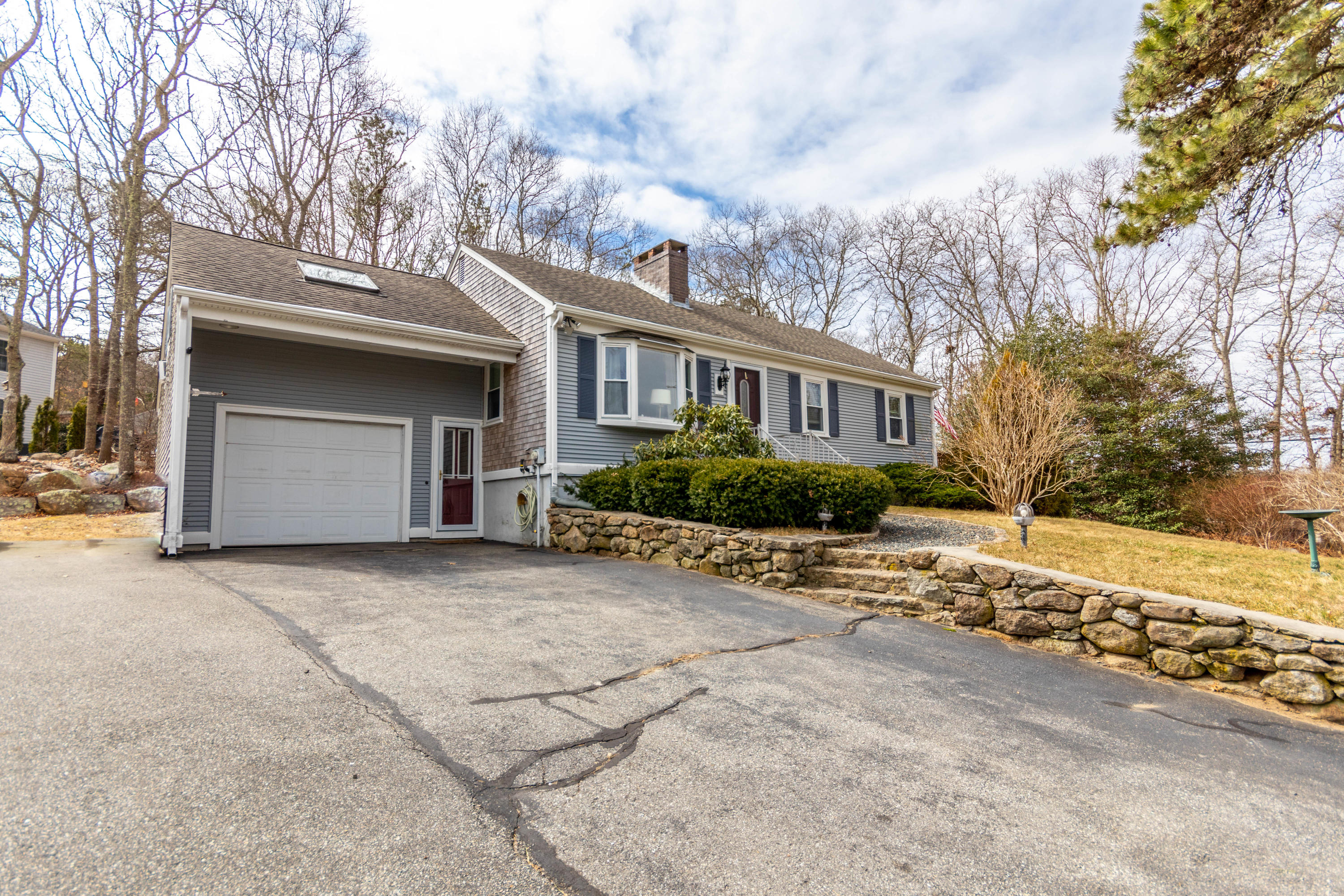 2 Long Boat Road Bourne, MA 02532 - Photo 26 of 30 a front view of a house with a yard and garage