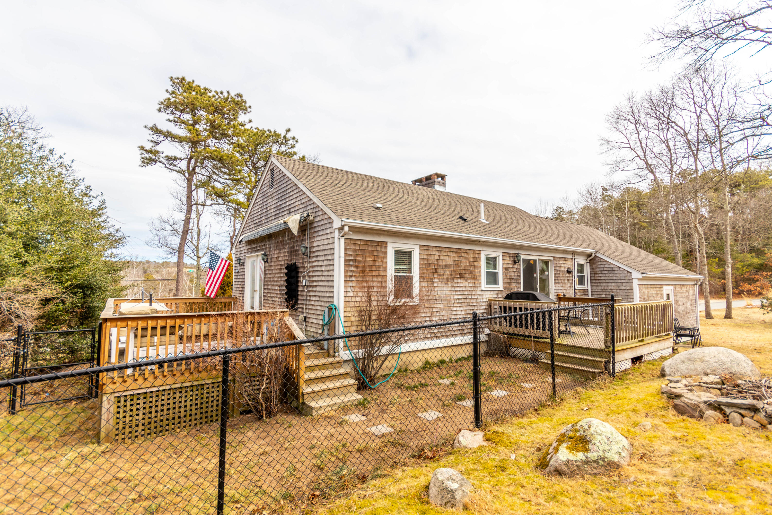 2 Long Boat Road Bourne, MA 02532 - Photo 3 of 30 a view of a house with a wooden fence