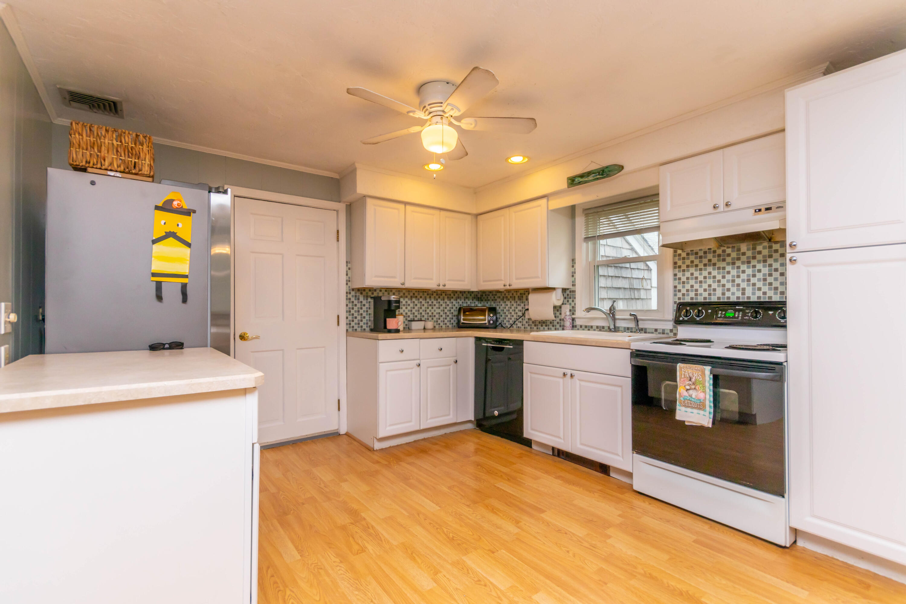 2 Long Boat Road Bourne, MA 02532 - Photo 7 of 30 a kitchen with a stove a sink and a refrigerator