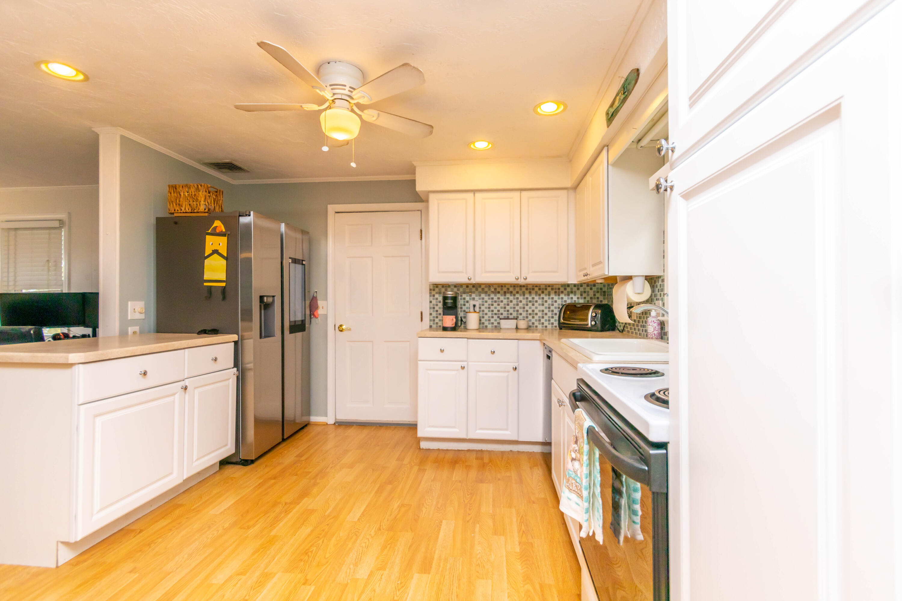 2 Long Boat Road Bourne, MA 02532 - Photo 8 of 30 a large white kitchen with cabinets appliances and a window