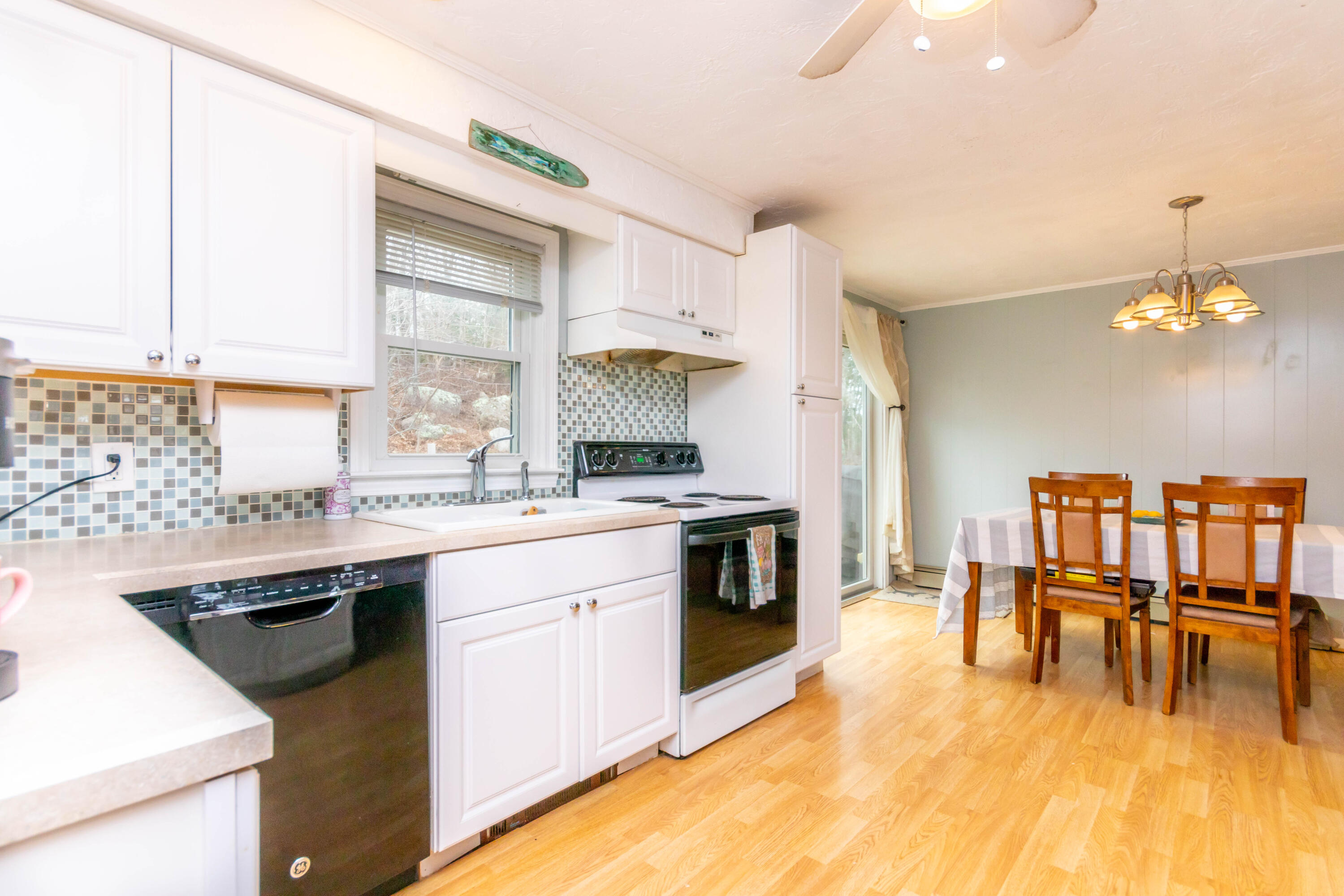 2 Long Boat Road Bourne, MA 02532 - Photo 10 of 30 a kitchen with a sink stove and cabinets