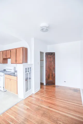 a view of a kitchen with wooden floor and a sink