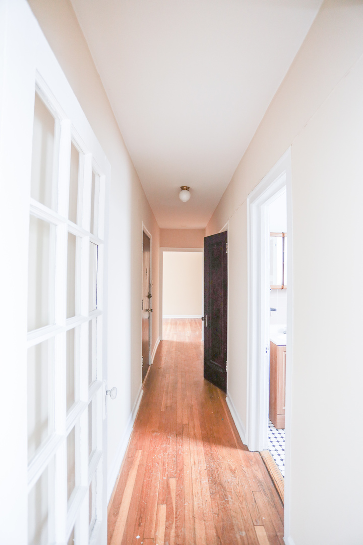 4724 West Addison Street, Unit 3A Chicago, IL 60641 - Photo 9 of 11 a view of a hallway with wooden floor and staircase