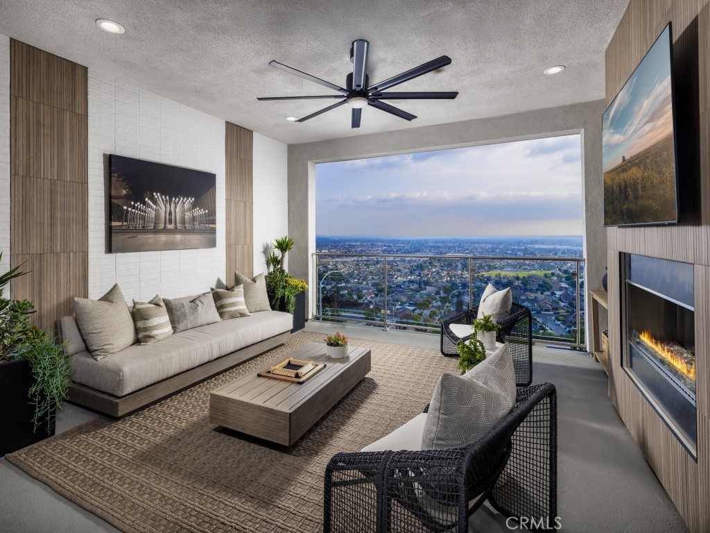 25 Remy Lane Montebello, CA 90640 - Photo 12 of 49 a living room with furniture a flat screen tv and a fireplace