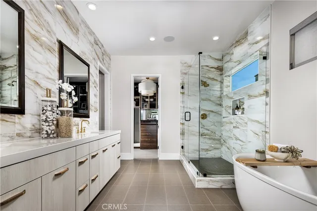 a bathroom with a double vanity sink a large mirror and a shower