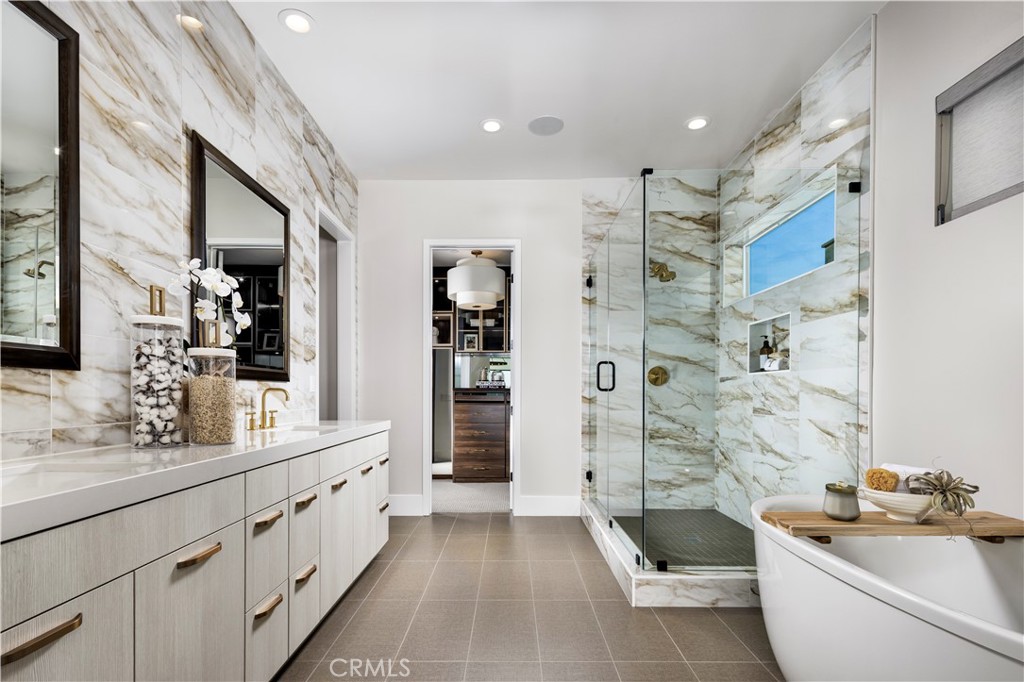 25 Remy Lane Montebello, CA 90640 - Photo 17 of 49 a bathroom with a double vanity sink a large mirror and a shower