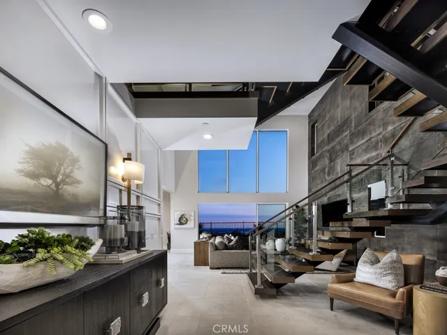 a living room with furniture and a kitchen view