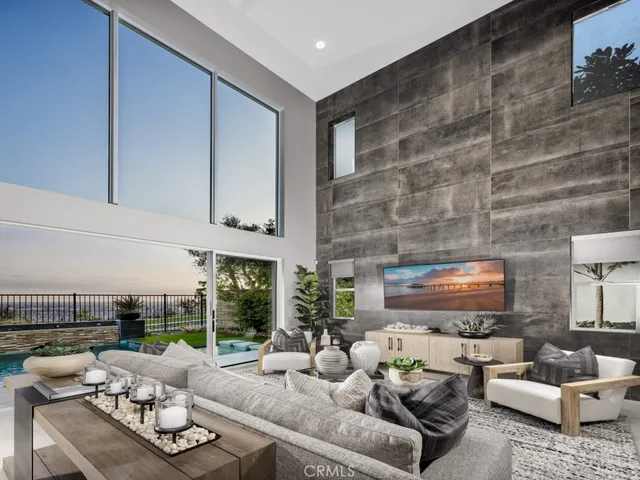 a living room with furniture and a floor to ceiling window