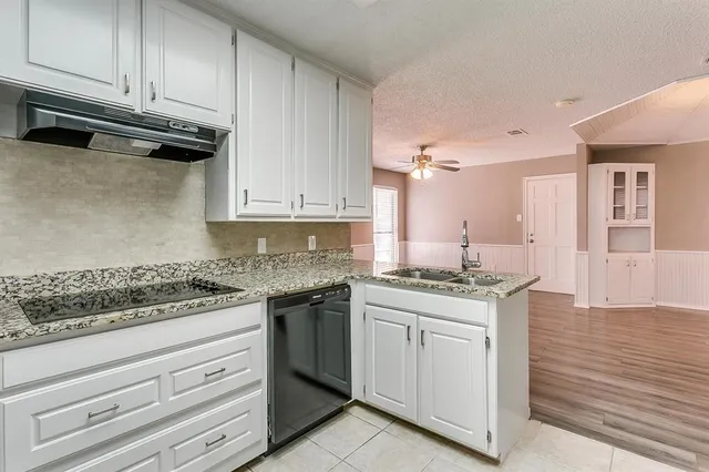 a kitchen with stainless steel appliances granite countertop a stove and a sink