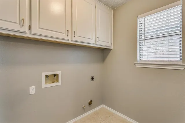 a bathroom with white cabinets