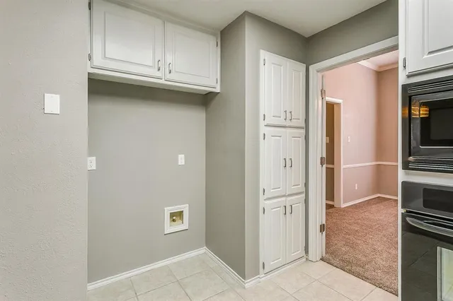 a view of a kitchen with refrigerator and cabinet