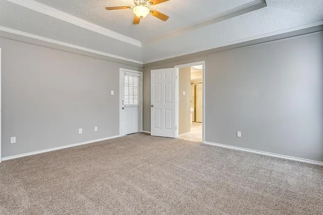 a view of an empty room with a chandelier fan