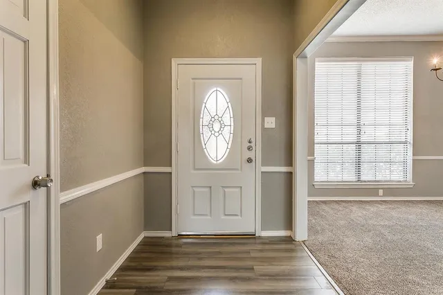 a view of an entryway with wooden floor