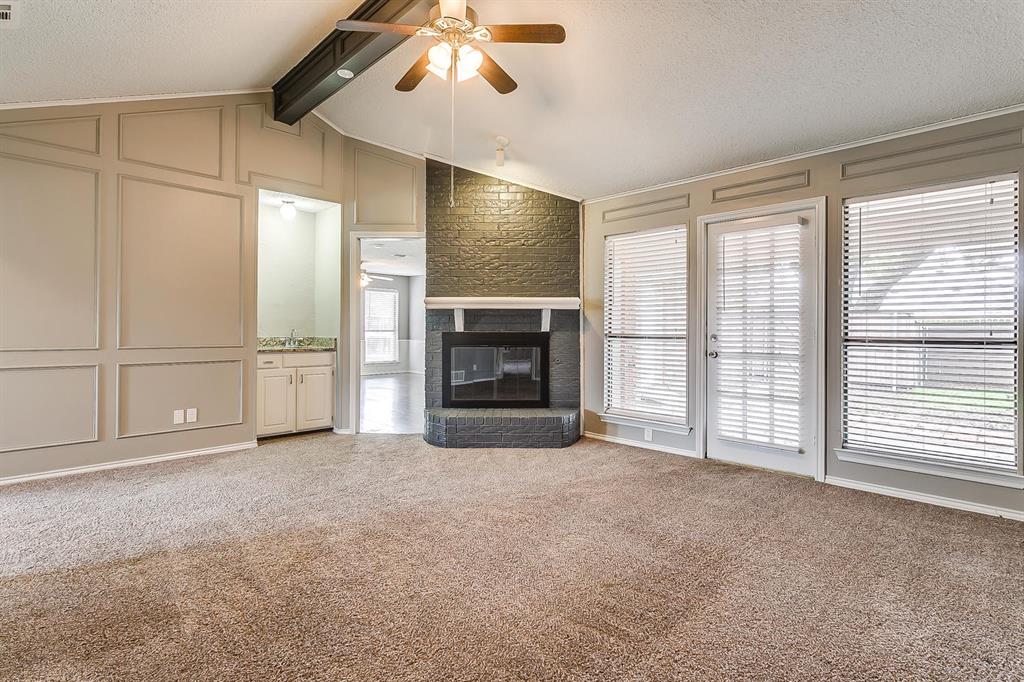2407 Ridgevalley Drive McKinney, TX 75071 - Photo 8 of 28 a view of an empty room with a fireplace and a window