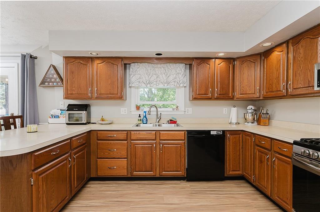979 Barclay Road Indiana, PA 15701 - Photo 12 of 37 a kitchen with stainless steel appliances granite countertop a sink dishwasher stove and cabinets