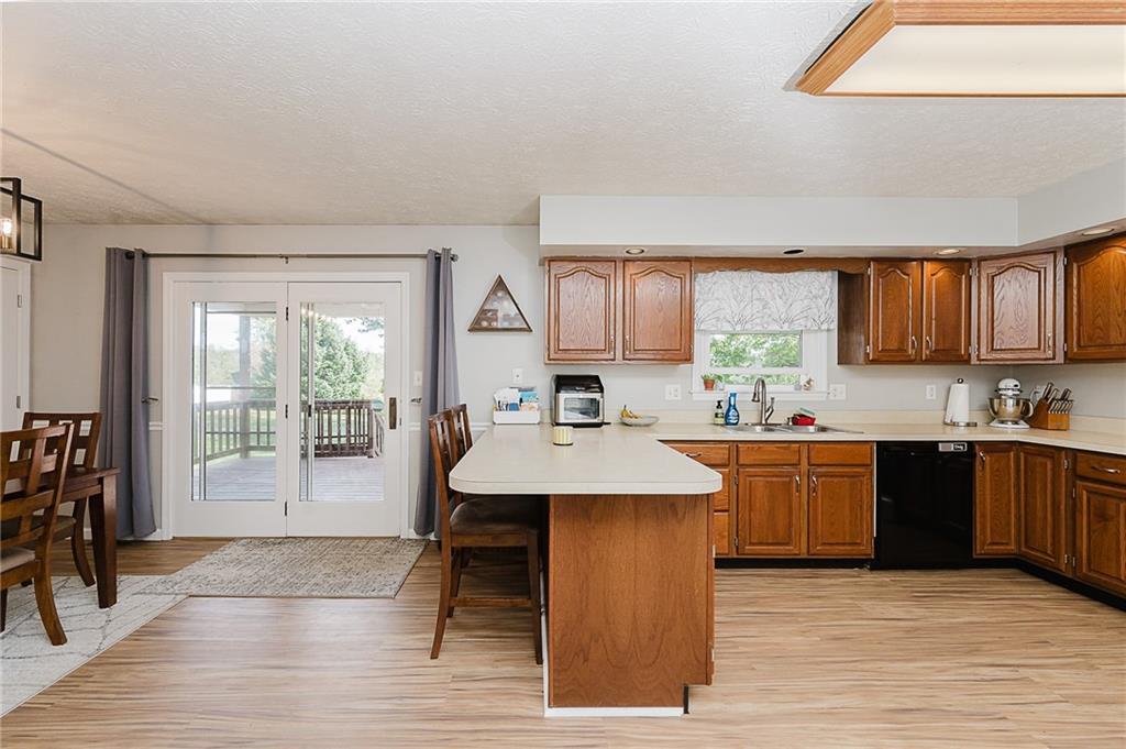 979 Barclay Road Indiana, PA 15701 - Photo 15 of 37 a kitchen with stainless steel appliances granite countertop a stove a sink a refrigerator a dining table and chairs with wooden floor