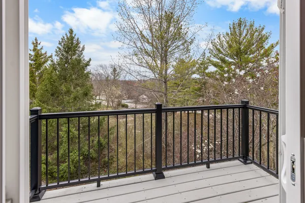 a view of balcony with wooden floor and fence