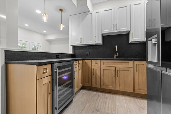 a kitchen with stainless steel appliances granite countertop a sink and a refrigerator