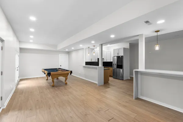 a view of kitchen with stainless steel appliances refrigerator sink and stove