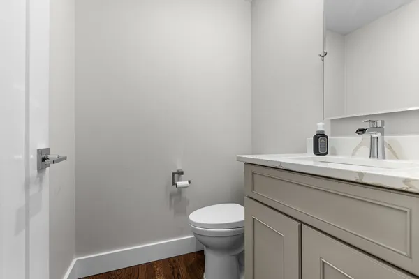 a bathroom with a toilet a sink and mirror