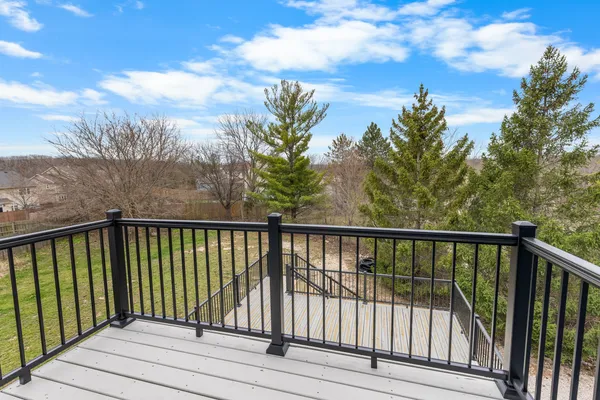 a view of balcony with wooden floor and fence