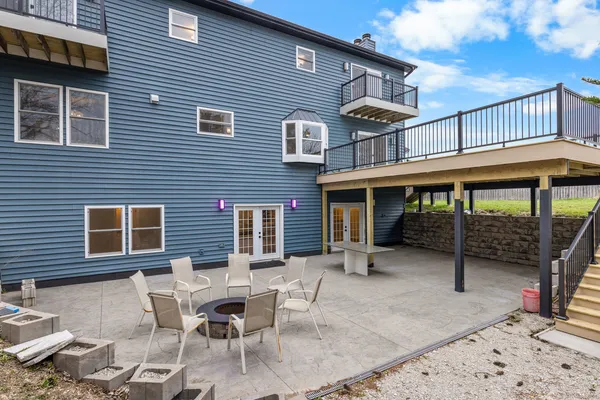 a view of a house with a patio and a yard