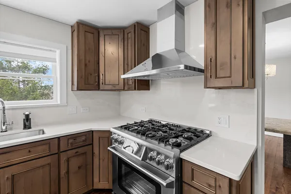 a kitchen with cabinets and a stove top oven