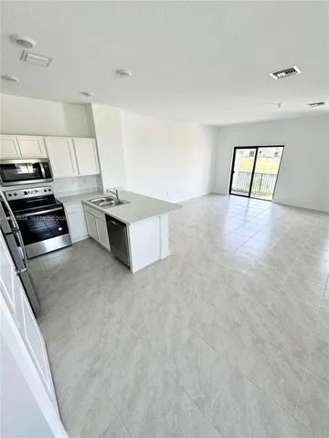 a kitchen that has a sink and a stove