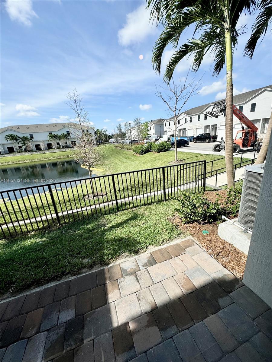 891 Northwest 3rd Street, Unit 891 Pompano Beach, FL 33060 - Photo 15 of 33 a view of a pathway with a wrought fence