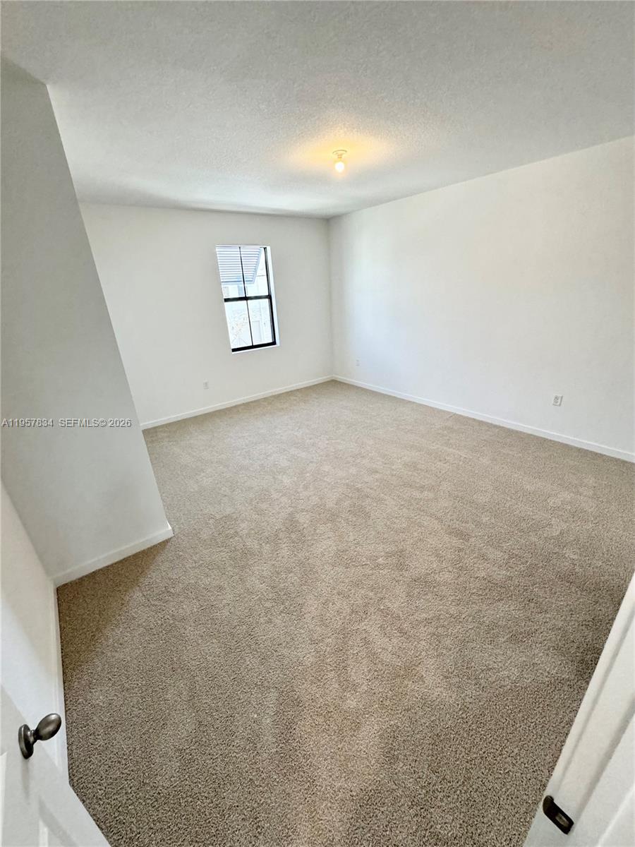 891 Northwest 3rd Street, Unit 891 Pompano Beach, FL 33060 - Photo 20 of 33 an empty room with windows