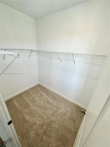 a view of an empty room with a mirror