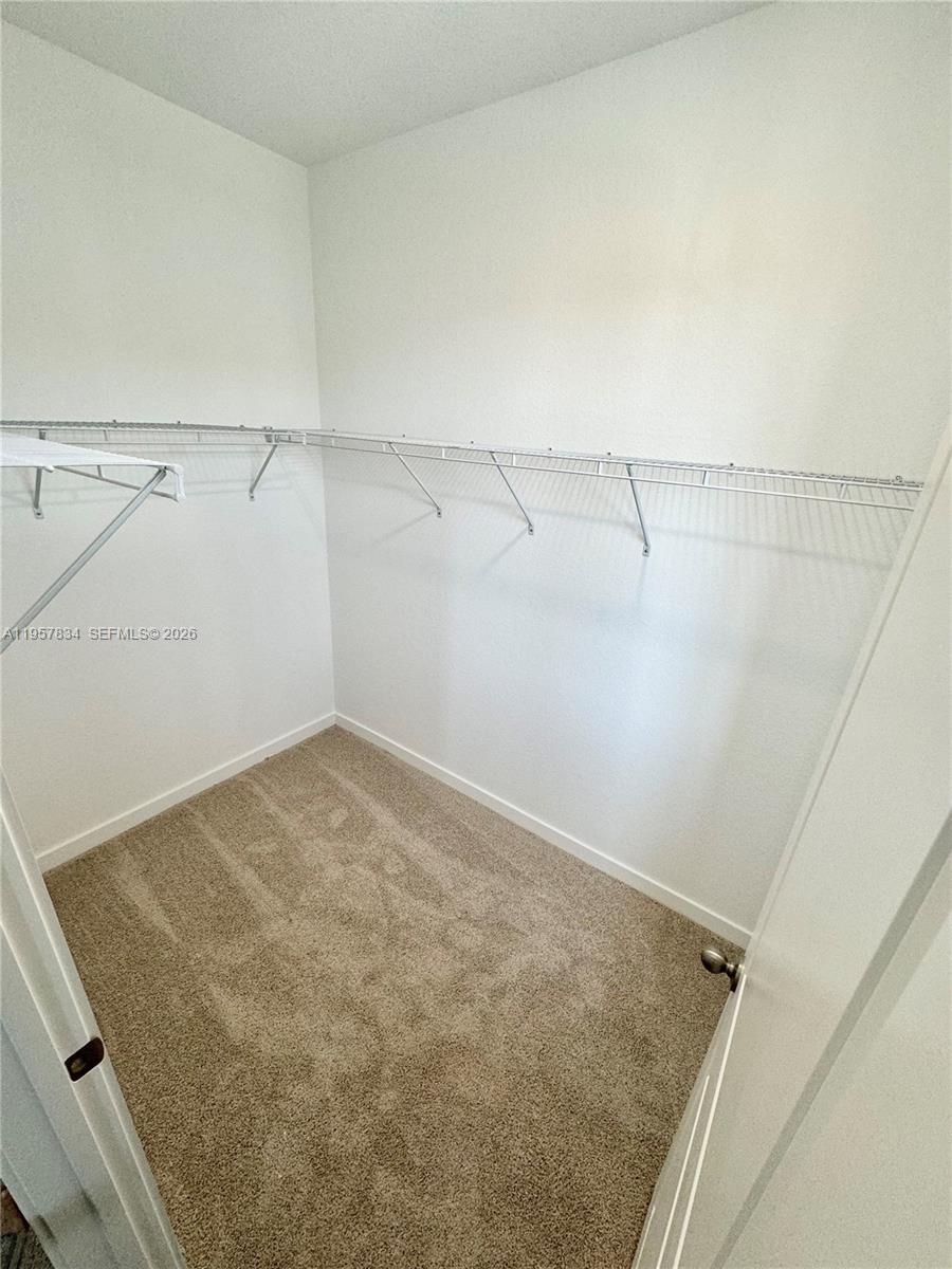 891 Northwest 3rd Street, Unit 891 Pompano Beach, FL 33060 - Photo 23 of 33 a view of a room with racks on the wall