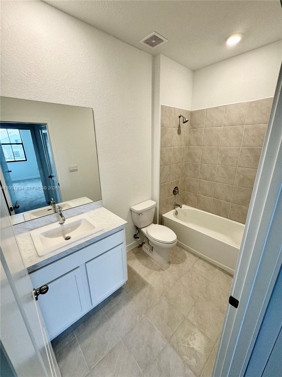 891 Northwest 3rd Street, Unit 891 Pompano Beach, FL 33060 - Photo 29 of 33 a bathroom with a double vanity sink toilet and shower