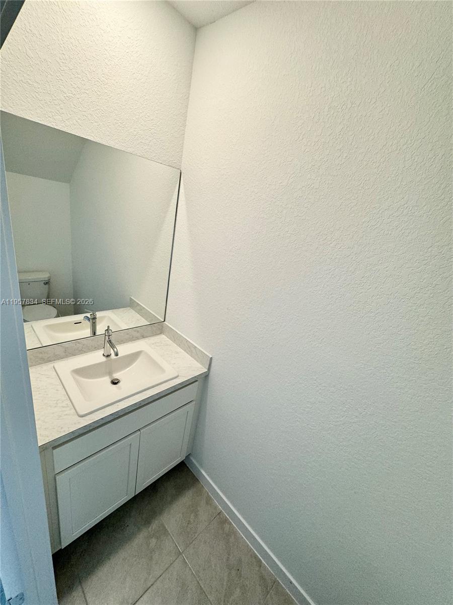 891 Northwest 3rd Street, Unit 891 Pompano Beach, FL 33060 - Photo 8 of 33 a bathroom with a sink and a mirror