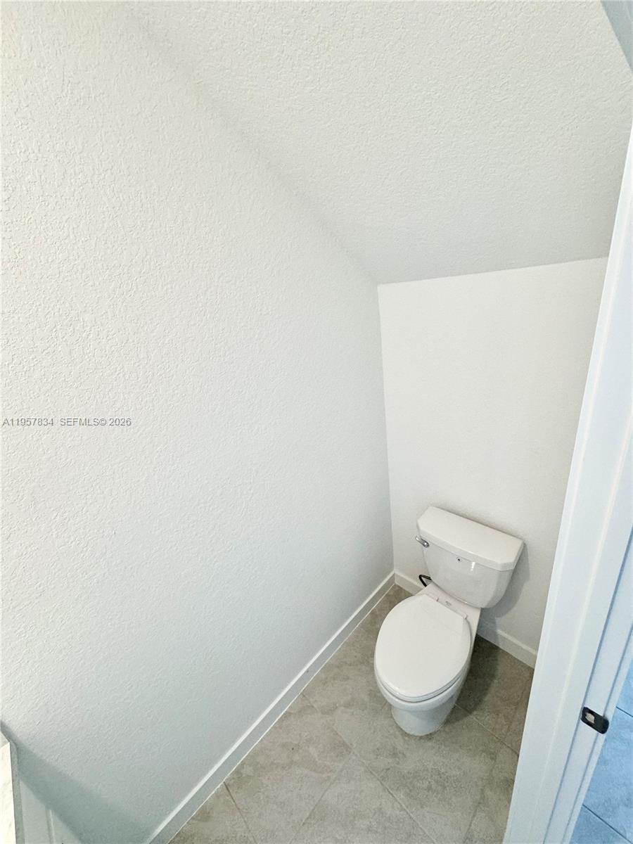 891 Northwest 3rd Street, Unit 891 Pompano Beach, FL 33060 - Photo 9 of 33 a white toilet sitting next to a white sink