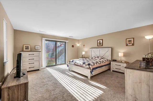 a bedroom with a bed and a view of bedroom