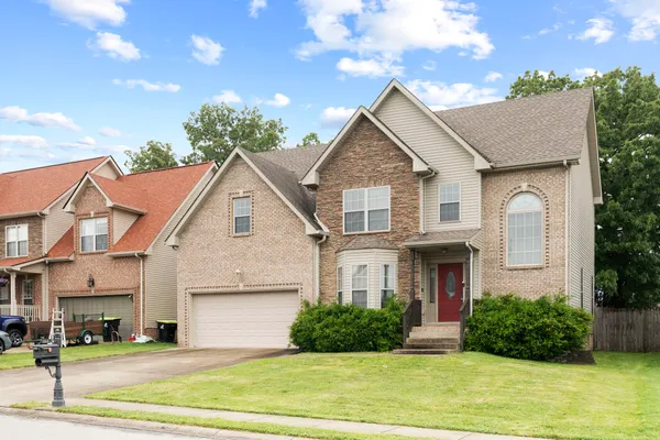 a front view of a house with a yard