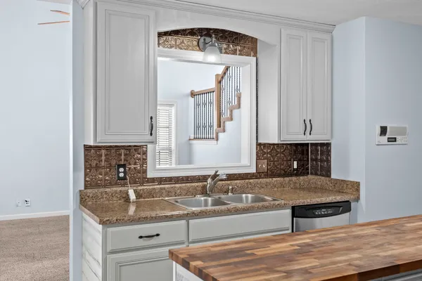 a kitchen with granite countertop a sink and a stove