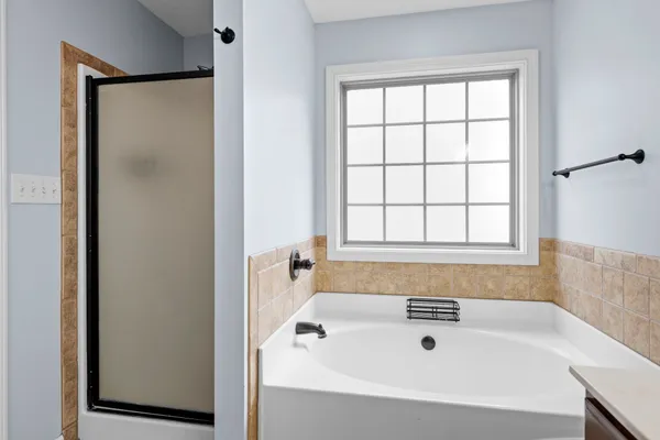 a bathroom with a bathtub and window