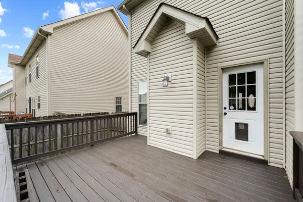 a view of a house with wooden deck