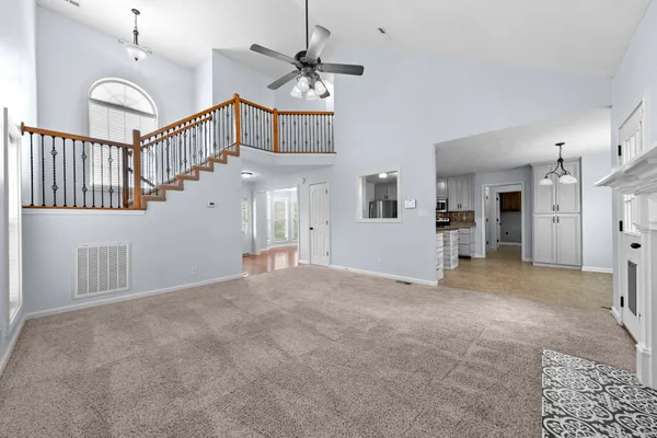 a view of a hallway with entryway and chandelier