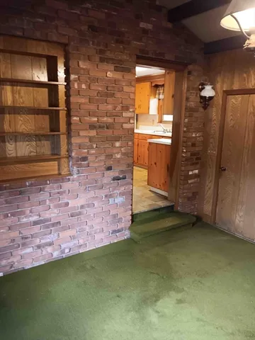 a view of an empty room with a fireplace