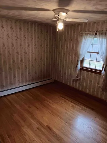 a view of a room with wooden floor
