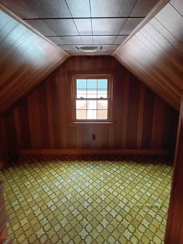 a view of a room with wooden walls
