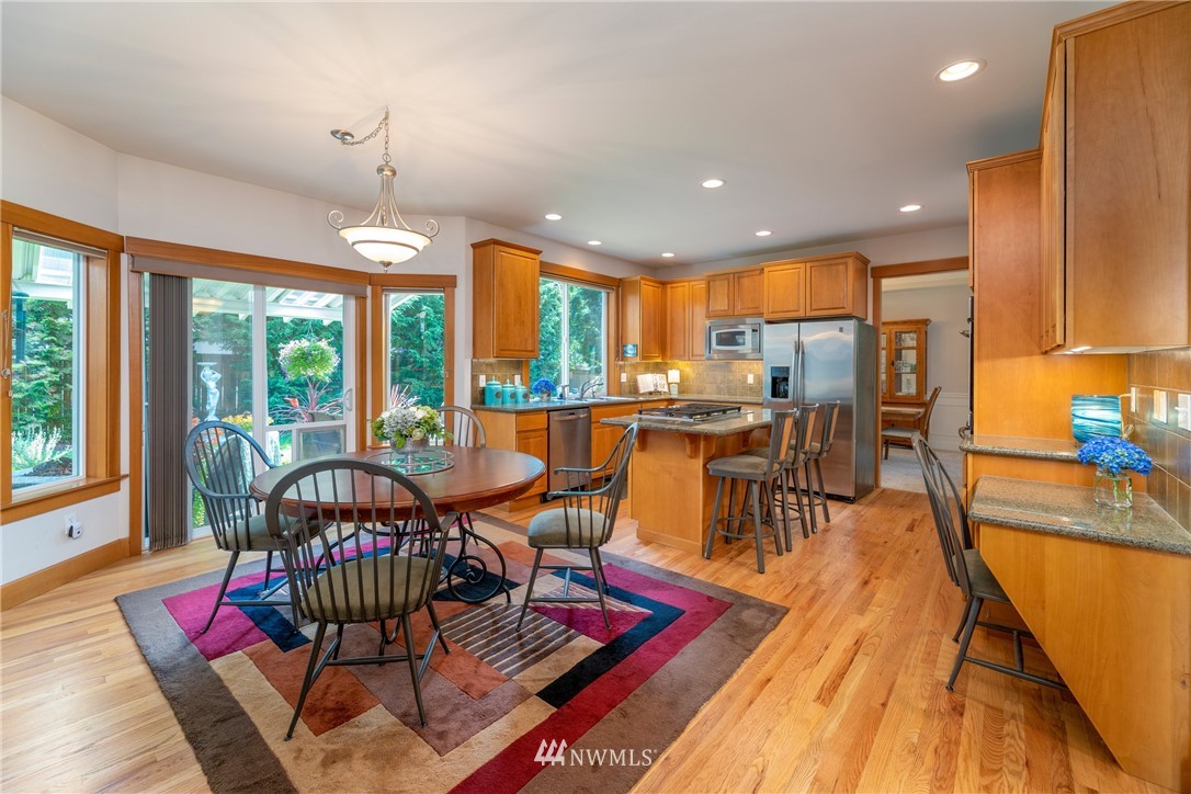 22421 6th Place West Bothell, WA 98021 - Photo 8 of 40 a dining room with furniture water view and large windows