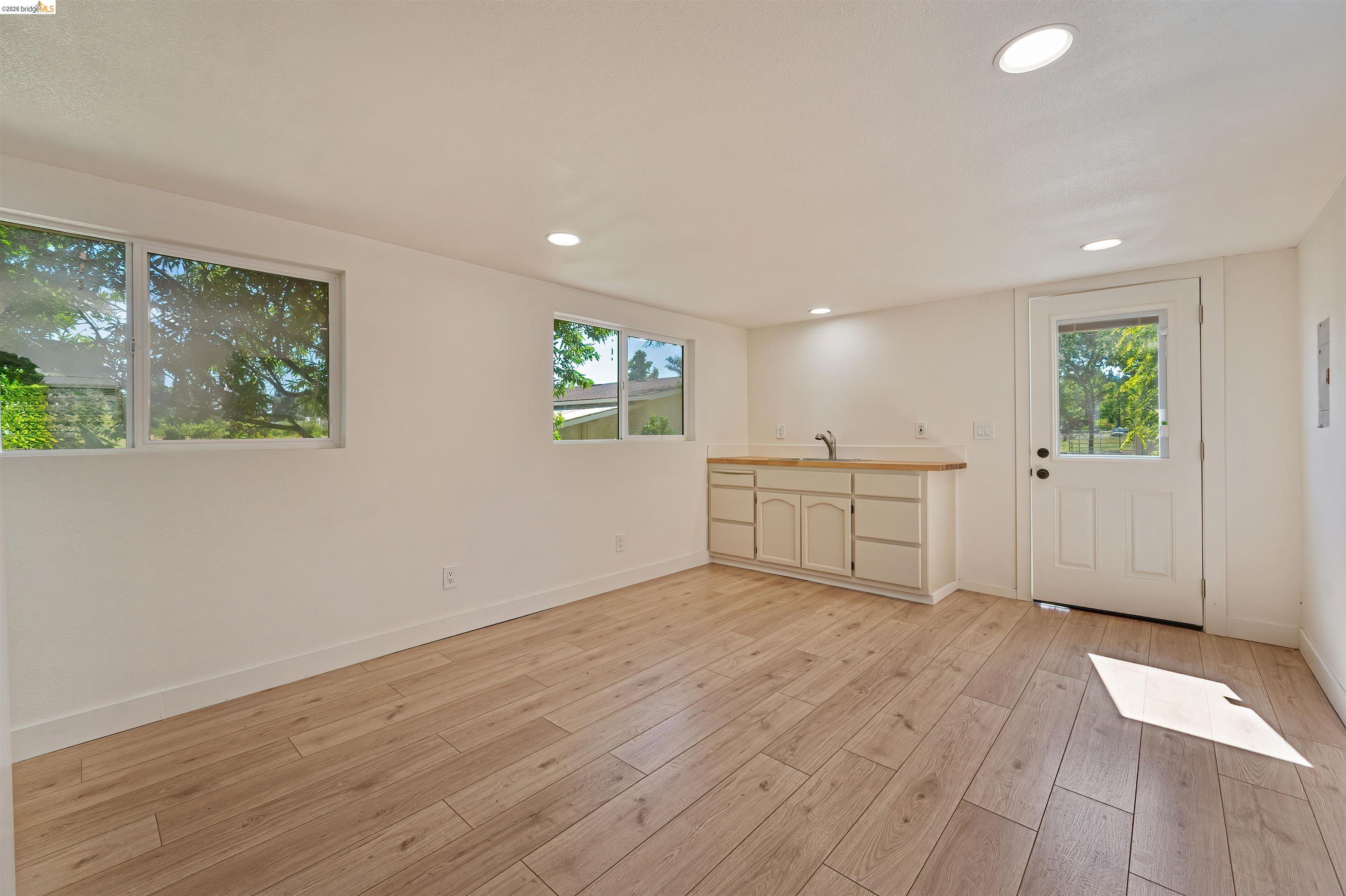 10474 Sheldon Road Elk Grove, CA 95624 - Photo 66 of 83 Spacious room featuring wood-finish flooring, recessed lighting, and multiple windows