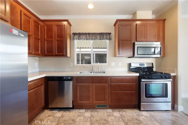 a kitchen with stainless steel appliances granite countertop a stove top oven a sink and dishwasher