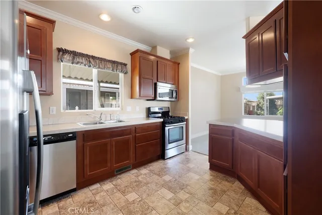 a large kitchen with stainless steel appliances granite countertop a stove and a sink